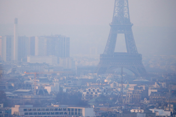 The Eiffel Tower is surrounded by a small-particle haze which hangs above the skyline in Paris