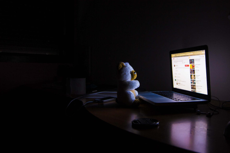 An open laptop in a dark room.