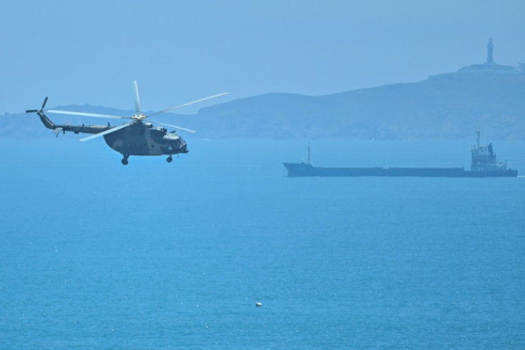 A Chinese military helicopter flies past Pingtan island, one of mainland China's closest points from Taiwan, in Fujian province on August 4, 2022 ahead of massive military drills off Taiwan following US House Speaker Nancy Pelosi's visit