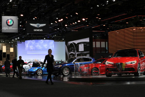 Attendees walk past Alfa Romeo vehicles at the North American International Auto Show in Detroit, Michigan