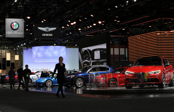 Attendees walk past Alfa Romeo vehicles at the North American International Auto Show in Detroit, Michigan