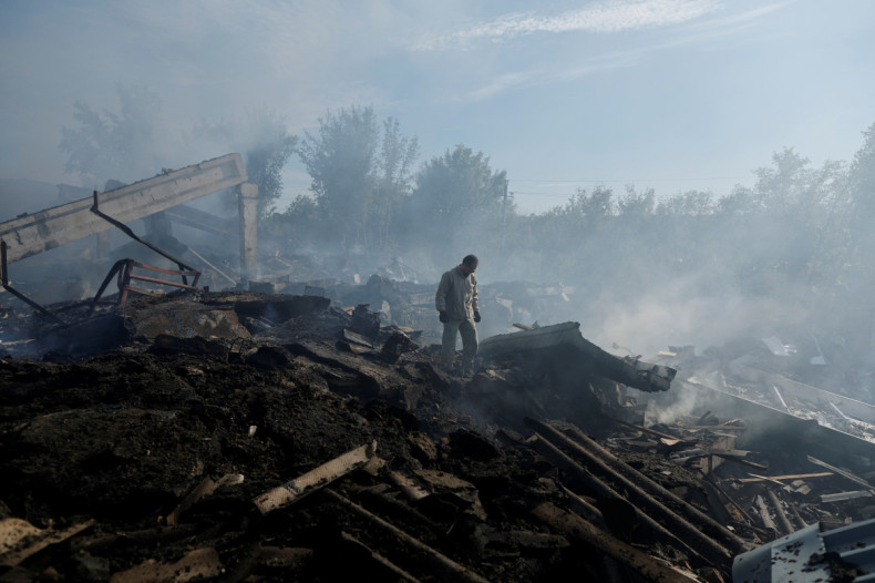 Ukrainian man stands at a destroyed wholesale market after a Russian strike in Kramatorsk