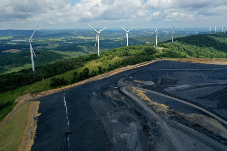 A wind farm overlooks a coal-treatment facility in Oakland, Maryland