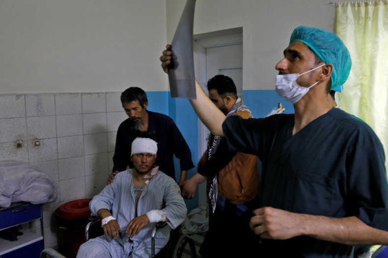 A medic checks an X-ray film of a wounded man inside a hospital in Kabul