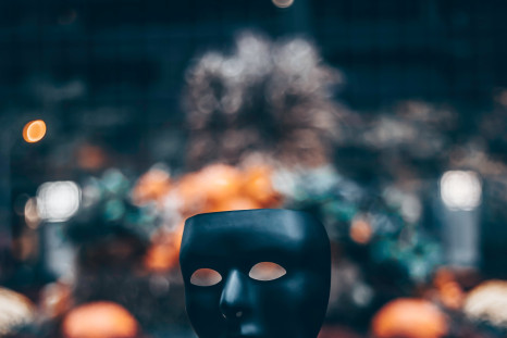 Person holding a black mask