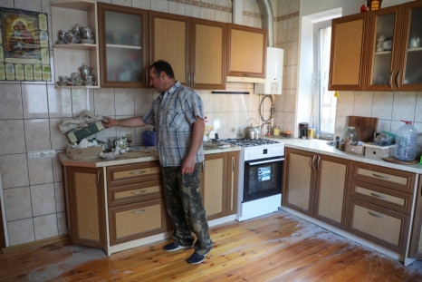Local resident Vitalii Zhyvotovskyi, 51, shows a Russian MRE in the kitchen of his house, which was used as a headquarter by Russian troops during Russia's invasion of the town of Bucha