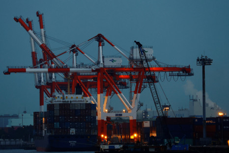 A cargo ship and containers are seen at an industrial port in Tokyo