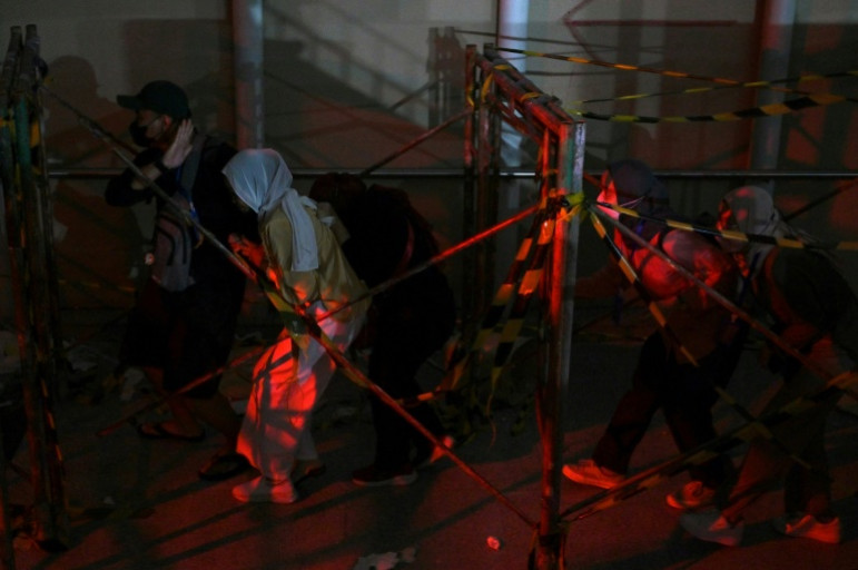 The zombies drag their feet toward passengers, sending them running through the dark station tunnels to a train