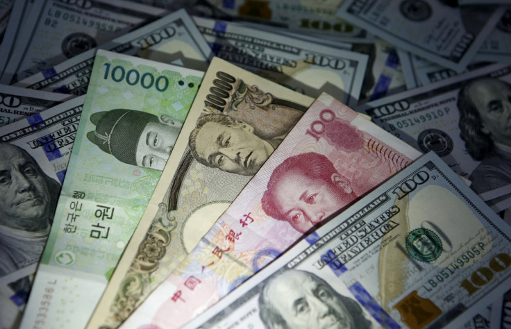 South Korean won, Chinese yuan and Japanese yen notes are seen on U.S. 100 dollar notes in this picture illustration taken in Seoul