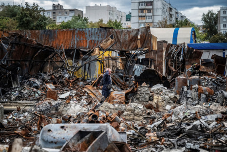 A local resident walks by a street market destroyed by military strikes, in Saltivka, one of the most damaged residential areas of Kharkiv
