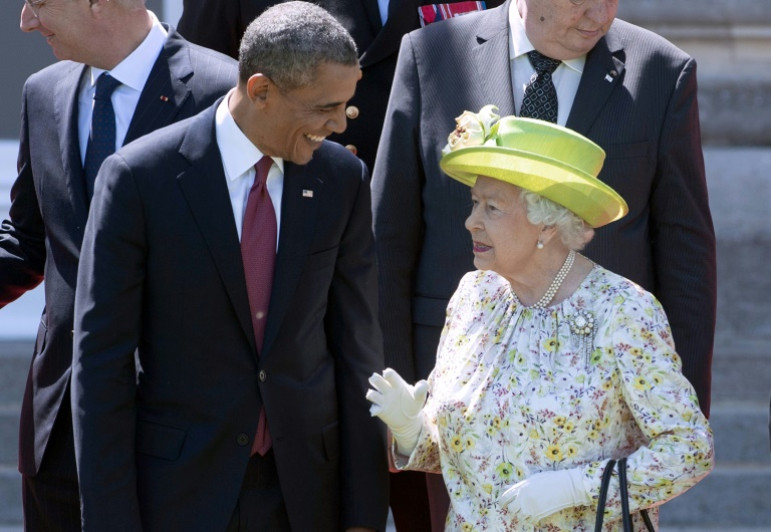 Queen Elizabeth II speaks with US President Barack Obama during a group photo of world leaders attending the D-Day 70th Anniversary ceremonies in France in 2014