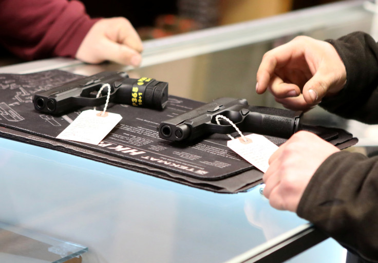 A woman shops for a handgun at Frontier Arms & Supply gun shop in Cheyenne