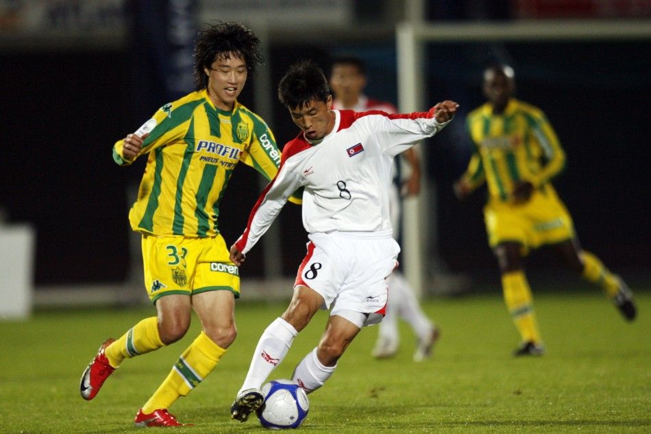 North Koreas Ji Yun-nam R fights for the ball with Nantes Lee Yong-jae L of South Korea during a friendly soccer match in La Roche sur Yon, October 9, 2009. North Korea has qualified for the World Cup 2010. 