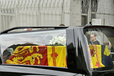 The hearse carrying the coffin of Queen Elizabeth II, draped in the Royal Standard of Scotland, is driven through Edinburgh towards the Palace of Holyroodhouse, on September 11, 2022