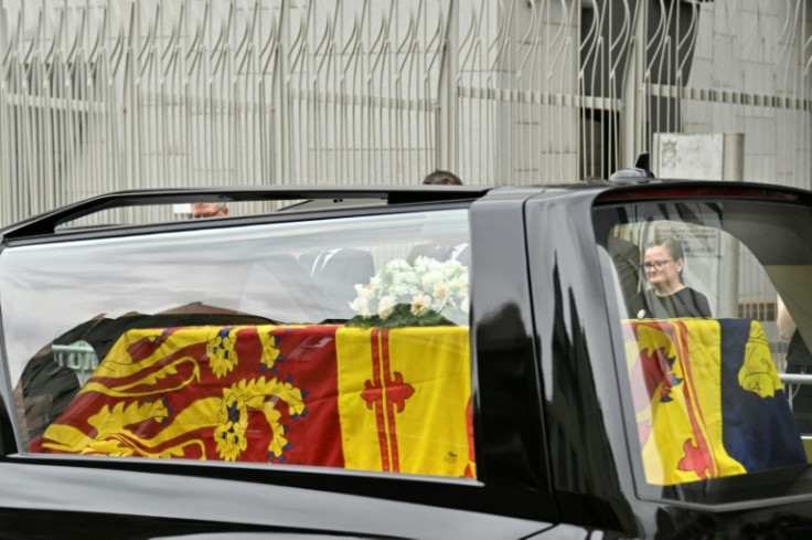 The hearse carrying the coffin of Queen Elizabeth II, draped in the Royal Standard of Scotland, is driven through Edinburgh towards the Palace of Holyroodhouse, on September 11, 2022