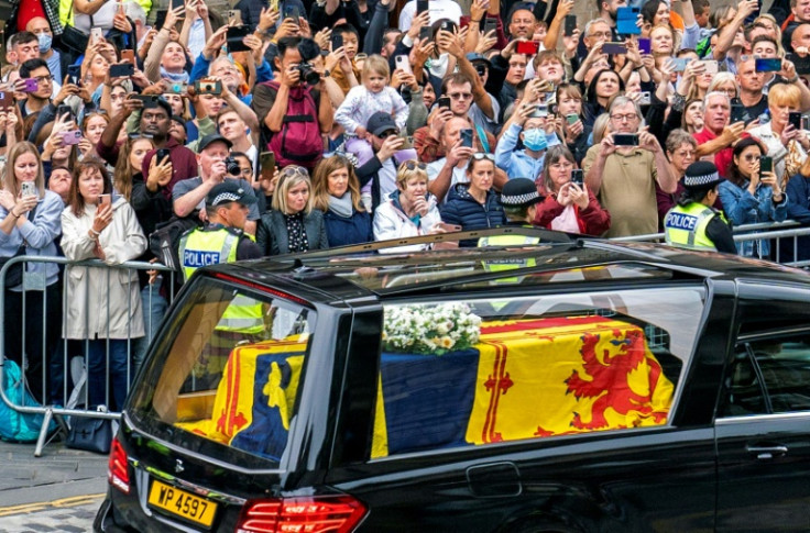 The coffin of Queen Elizabeth II, draped in the Royal Standard of Scotland, being driven through Edinburgh towards the Palace of Holyroodhouse, on September 11, 2022