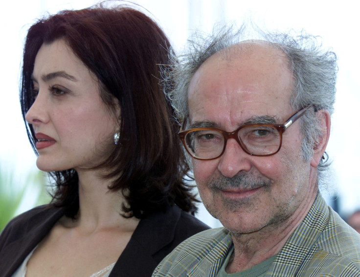 Swiss director Jean Luc Godard (R) smiles as he stands with actress Cecile Camp (L) for their film "..