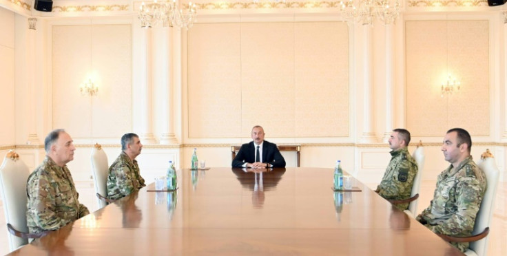 Azerbaijan, whose  President Ilham Aliyev met military leaders Tuesday, said it was responding to "large-scale subversive acts" by Armenia