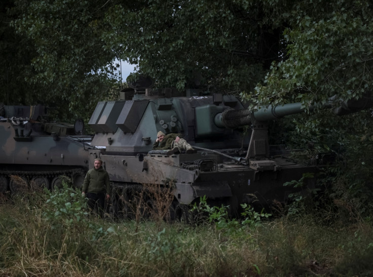 Ukrainian servicemen are seen near a Polish self-propelled howitzer Krab in Kharkiv region