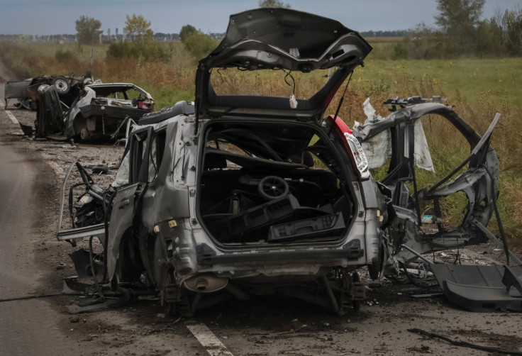 Destroyed civilian cars are seen on a road near the town of Balakliia