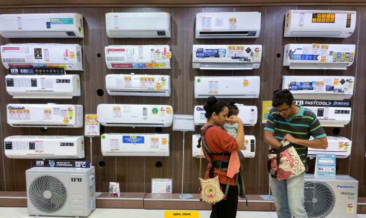 People shop for an air conditioner inside an electronics store in Mumbai