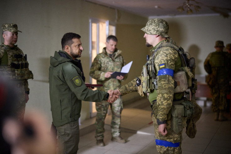 Ukraine's President Zelenskiy awards a Ukrainian service member near a frontline in Kharkiv region