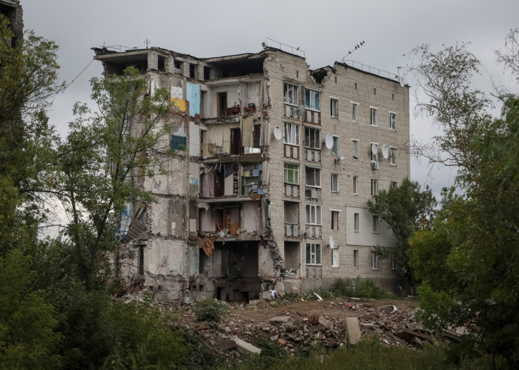 A damaged apartment house is seen in the town of Izium