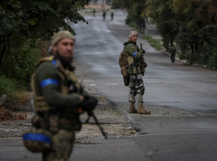 Ukrainian servicemen patrol an area, as Russia's attack on Ukraine continues, in the town of Izium