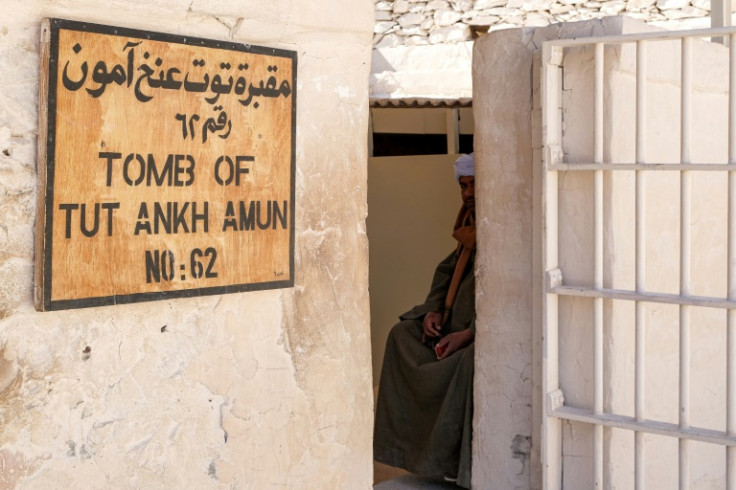 A caretaker sits outside the tomb of the pharaoh Tutankhamunin in the Valley of the Kings at Luxor