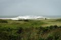 A person walks in the sand Dunes as heavy surf rolls onto the south shore of Martha's Vineyard island