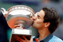 Federer of Switzerland kisses his trophy after winning the men's final against Soderling of Sweden at the French Open tennis tournament at Roland Garros in Paris