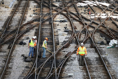 Workers service the tracks at the Metra/BNSF railroad yard outside of Chicago