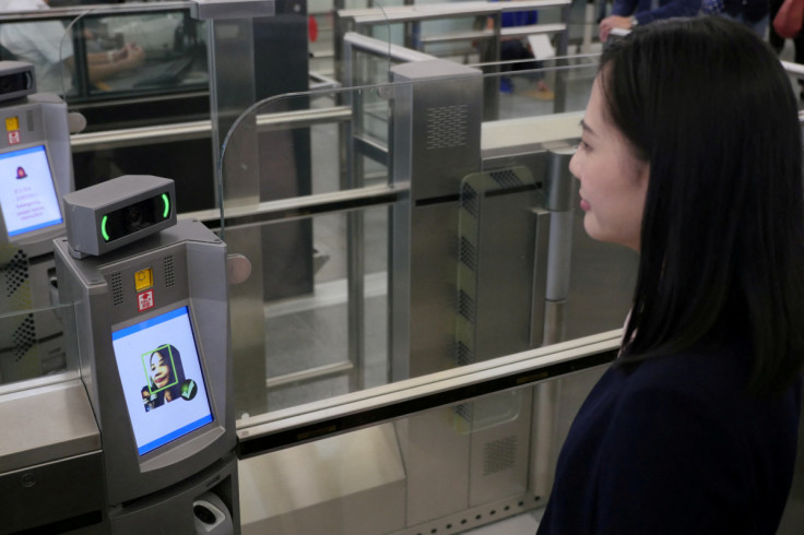 A "smart departure" self-service machine scans a woman's face to authenticate her identity during a demonstration at airport in Hong Kong