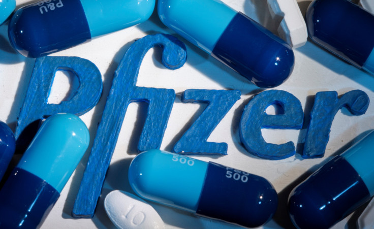 A 3D printed Pfizer logo is placed near medicines from the same manufacturer in this illustration