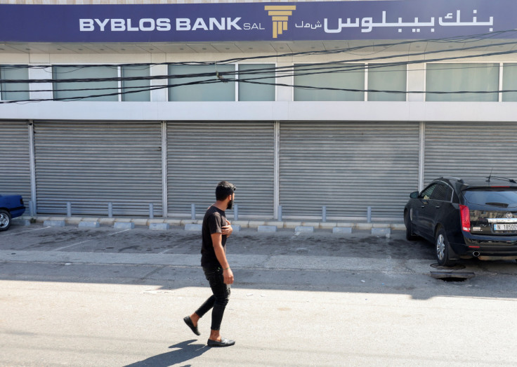A man walks outside a closed Byblos Bank branch in the southern city of Ghazieh