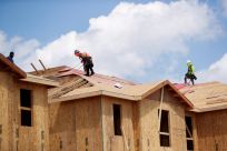 Carpenters work on building new townhomes in Tampa, Florida