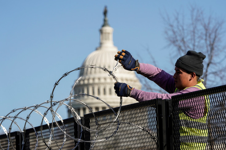 FILE PHOTO - Workers remove razor wire from security fencing near the U.S. Capitol in Washington