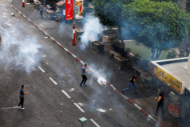 Palestinians protest the arrest of two militants by Palestinian security forces