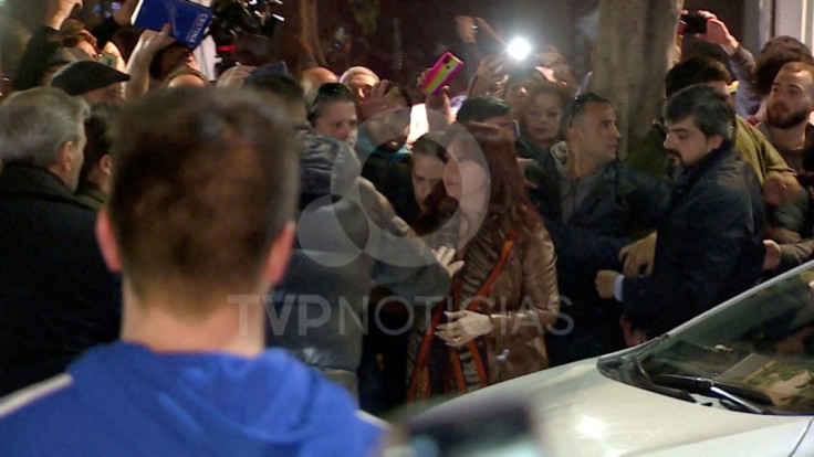 Argentina's Vice President Cristina Fernandez de Kirchner is escorted away after a man pointed a gun at her, with no shots fired, at the entrance of her home in Buenos Aires