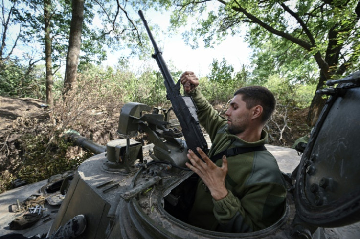 A Ukrainian serviceman handles a machine gun near the southern frontline in the Mykolaiv region