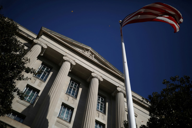 American flag waves outside the U.S. Department of Justice Building in Washington