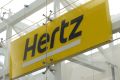 Signage is seen at Hertz rental car at John F. Kennedy International Airport in Queens, New York City