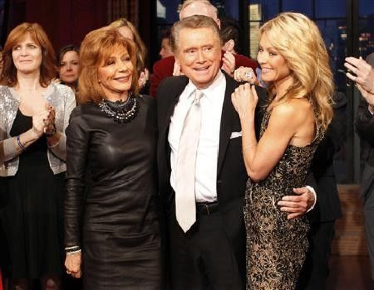 Television host Regis Philbin (C) says goodbye with his wife Joy Philbin (L) and co-host Kelly Ripa (R) during his final show of &quot;Live With Regis and Kelly&quot; in New York, November 18, 2011. After nearly three decades hosting the show that became 