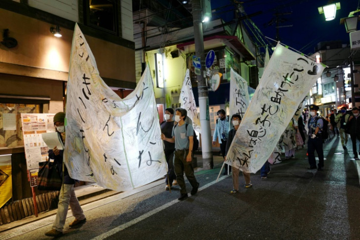 Protesters march with banners during a demonstration staged by former 'hikikomori', or shut-ins, in May 2022