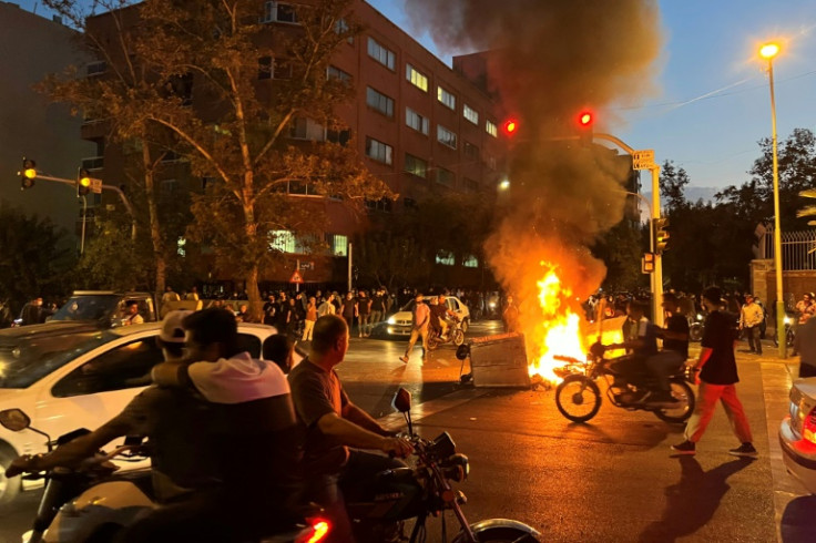 A picture obtained by AFP outside Iran shows a bin burning during a protest in Tehran on September 20, 2022