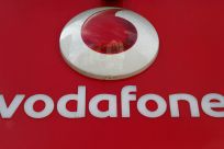 A branded sign is displayed on a Vodafone store in London