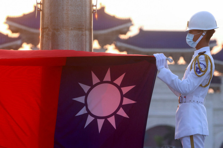 Honour guards lower the Taiwan flag during sunset hours at Liberty Square in Taipei,
