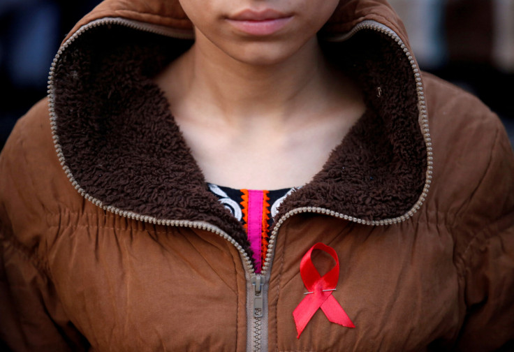 A participant with a red ribbon pin takes part in HIV/AIDS awareness campaign ahead of World Aids Day, in Kathmandu