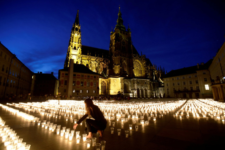 People light candles to commemorate COVID-19 victims in Prague