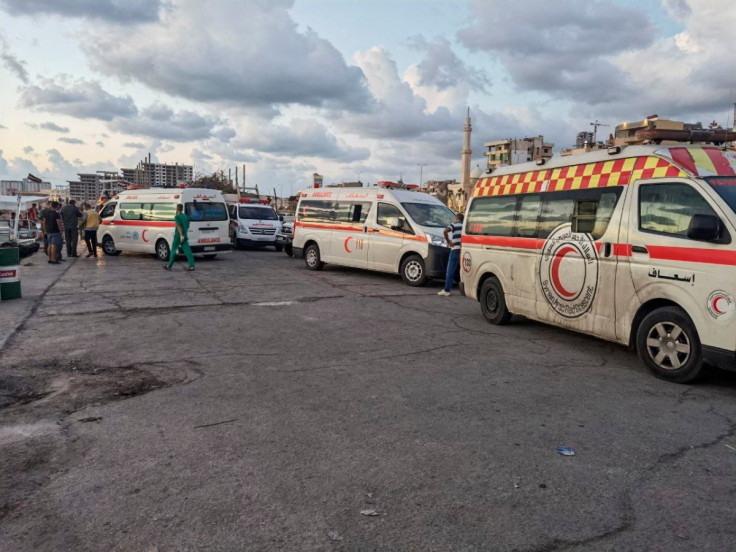 Ambulances are seen during the rescue process of migrants in the port of Tartous